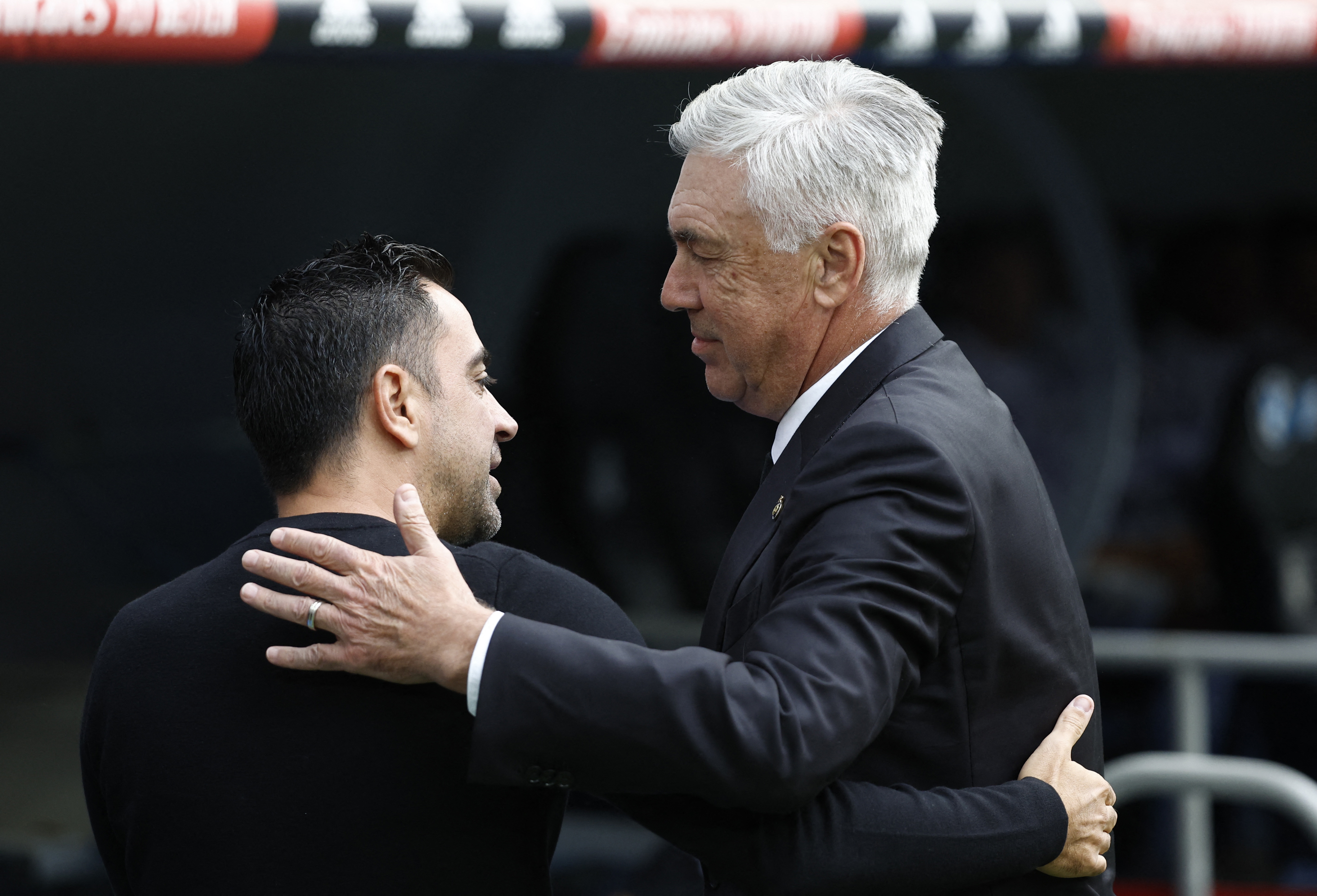 Real Madrid coach Carlo Ancelotti shakes hands with FC Barcelona coach Xavi before the match REUTERS/Juan Medina